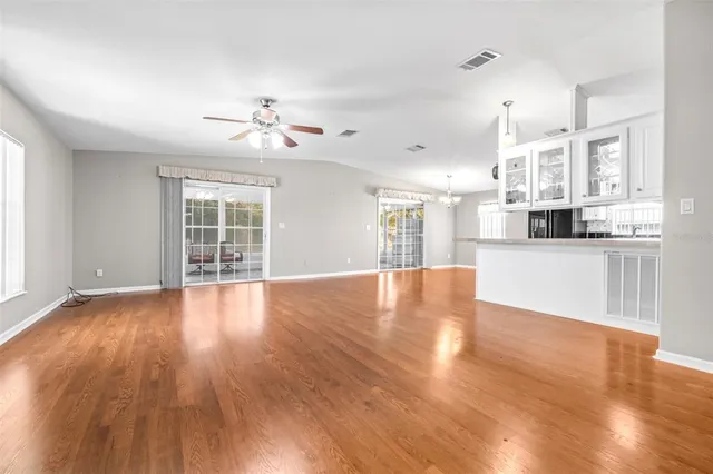 a view of a kitchen with wooden floor and a kitchen