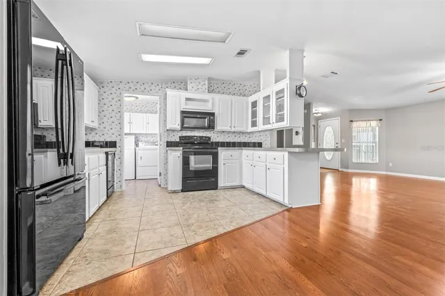 a large kitchen with cabinets and stainless steel appliances