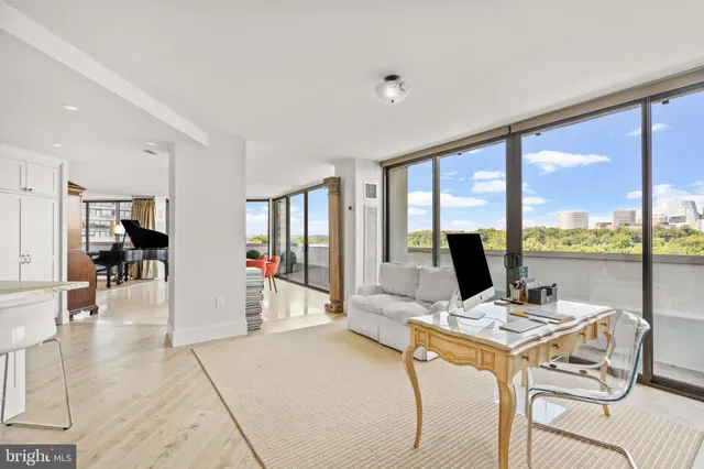 a view of a workspace with furniture and a backyard