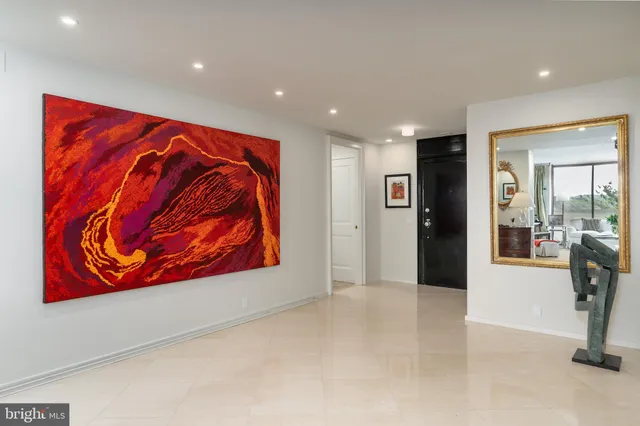 a kitchen with stainless steel appliances kitchen island granite countertop a refrigerator and cabinets