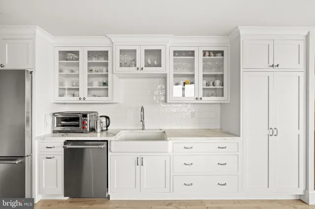 a kitchen with stainless steel appliances a refrigerator a stove and a sink