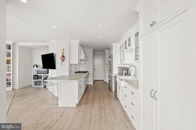 a kitchen with stove and cabinets