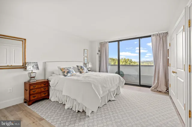 a bathroom with a tub shower sink and mirror