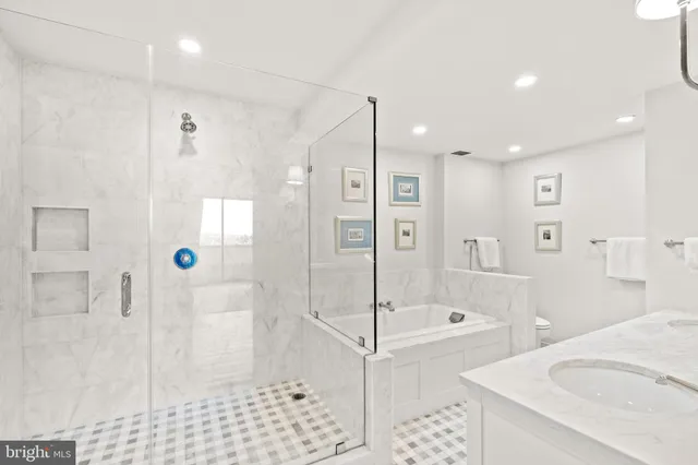 a bathroom with a double vanity sink mirror and shower