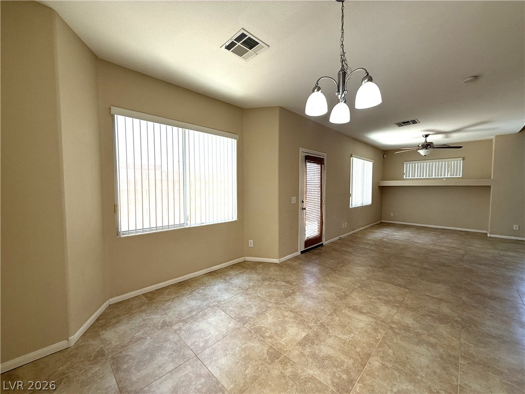 5942 Rampolla Drive Las Vegas, NV 89141 - Photo 6 of 27 A well-lit interior space with tile flooring and a view of the outdoors.