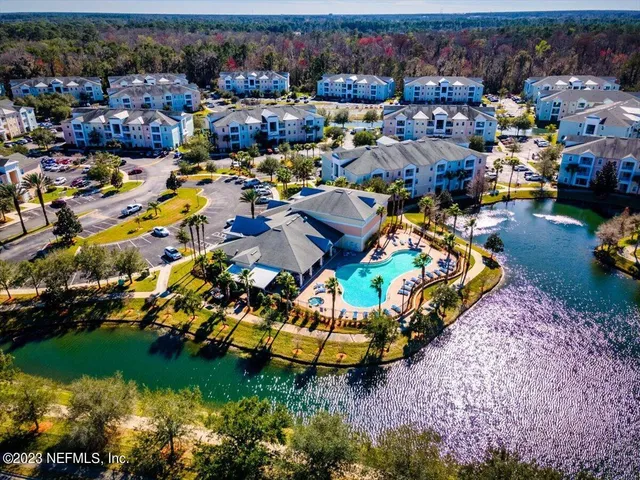 an aerial view of a house with a garden and swimming pool