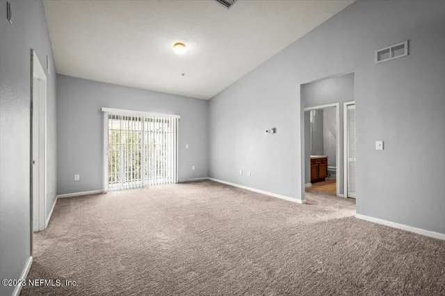 a view of an empty room with a window