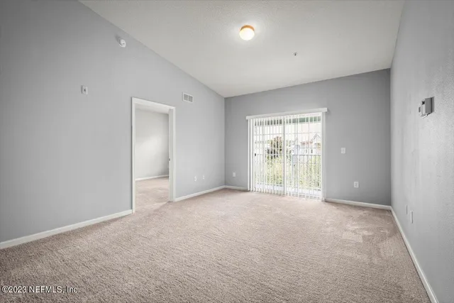 an empty room with a empty space and windows