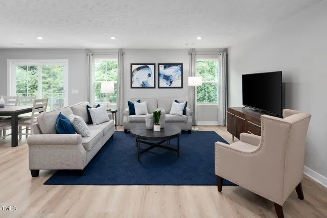 a living room with furniture wooden floor and a flat screen tv