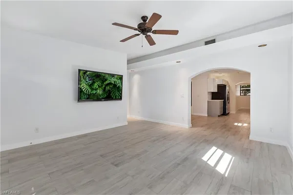 a view of empty room with wooden floor