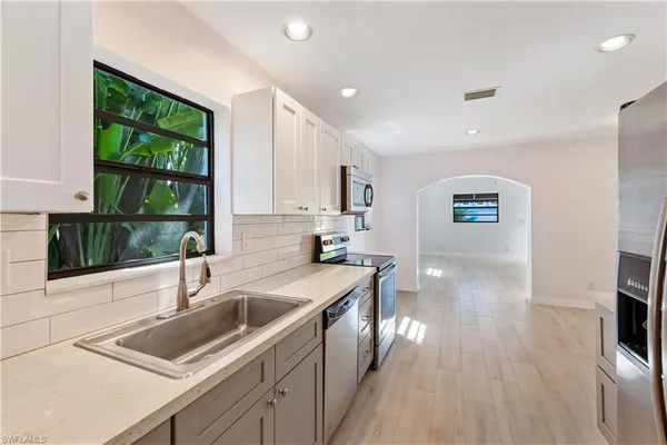 a kitchen with stainless steel appliances a refrigerator and a stove top oven