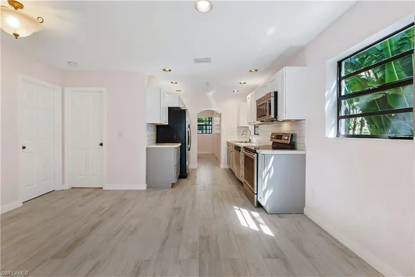 a kitchen with stainless steel appliances a stove microwave and refrigerator