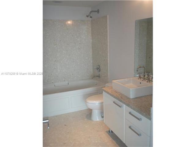 185 Southwest 7th Street, Unit 1909 Miami, FL 33130 - Photo 5 of 6 a bathroom with a sink a toilet and shower