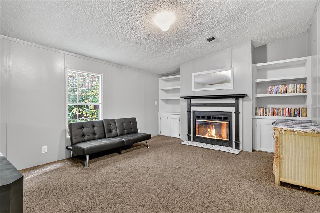 42312 Webster Street Altoona, FL 32702 - Photo 11 of 30 a living room with furniture and a fireplace