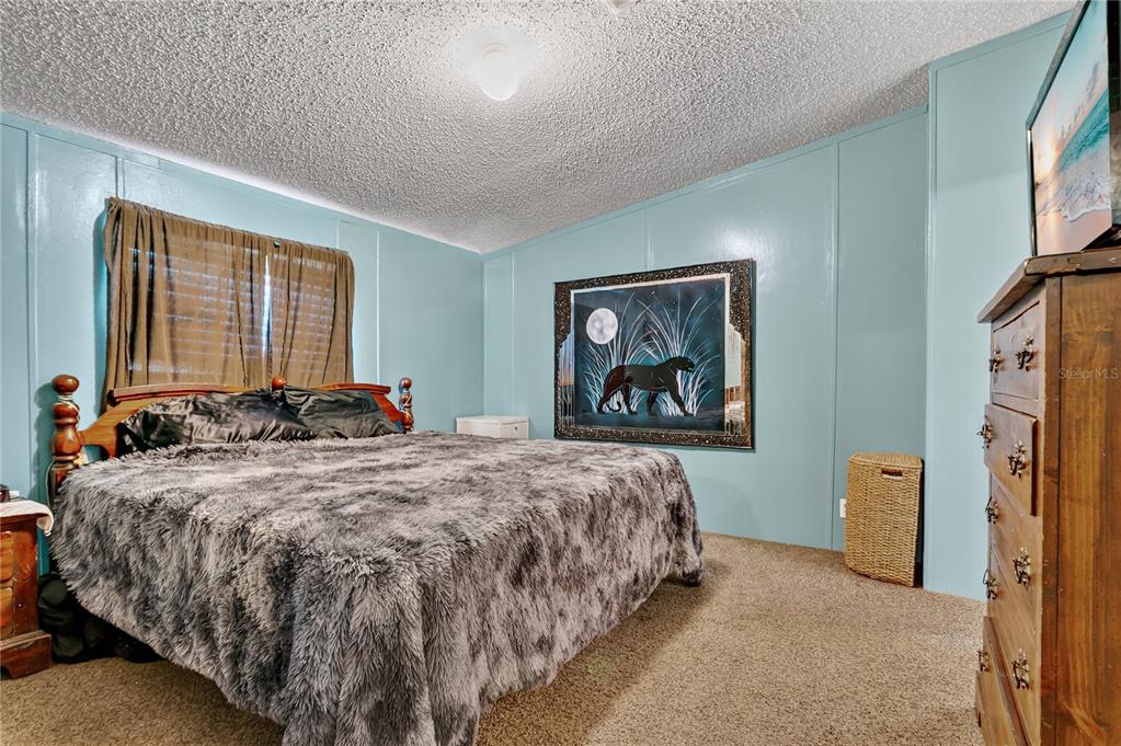 42312 Webster Street Altoona, FL 32702 - Photo 16 of 30 a bed sitting in a spacious bedroom next to a window