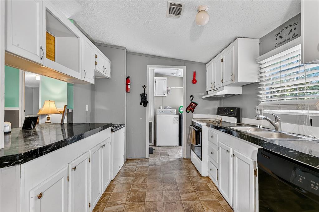 42312 Webster Street Altoona, FL 32702 - Photo 5 of 30 a kitchen with stainless steel appliances granite countertop a sink stove and cabinets