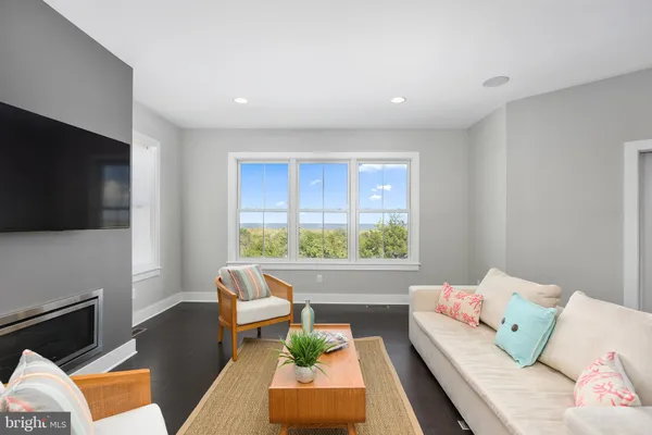 a living room with furniture fireplace and a flat screen tv
