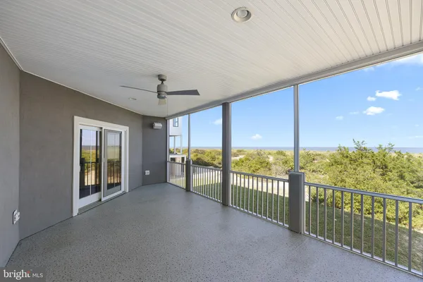 wooden floor in an empty room with a large window