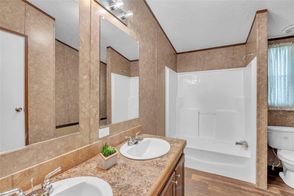 1448 Boys Ranch Road Waco, TX 76705 - Photo 18 of 31 a bath room with a granite countertop sink and a mirror