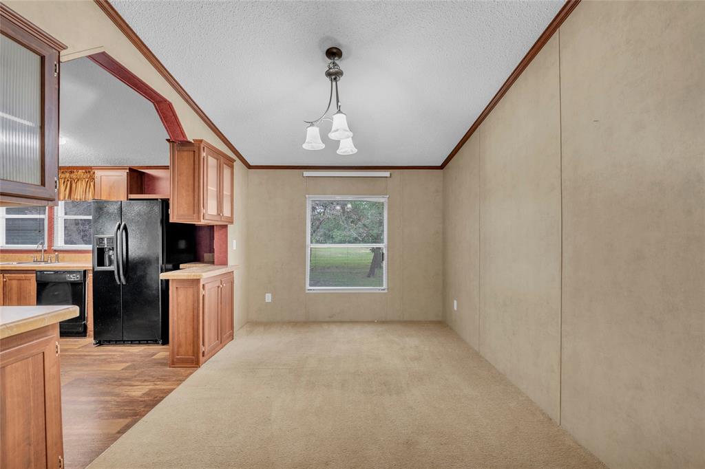 1448 Boys Ranch Road Waco, TX 76705 - Photo 22 of 31 a view of a kitchen with a stove cabinets and a floor to ceiling window