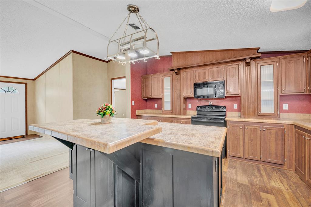 1448 Boys Ranch Road Waco, TX 76705 - Photo 26 of 31 a kitchen with stainless steel appliances granite countertop a sink refrigerator and cabinets