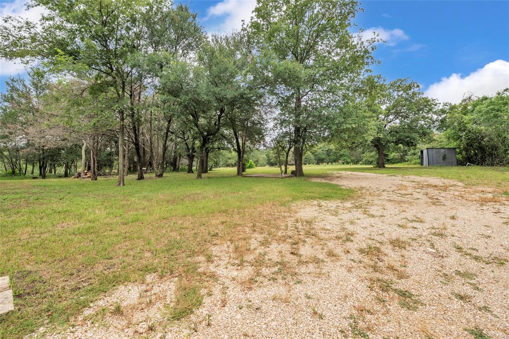 1448 Boys Ranch Road Waco, TX 76705 - Photo 27 of 31 a view of a field with trees in the background