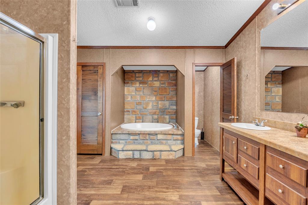1448 Boys Ranch Road Waco, TX 76705 - Photo 9 of 31 a spacious bathroom with a double vanity sink and a mirror