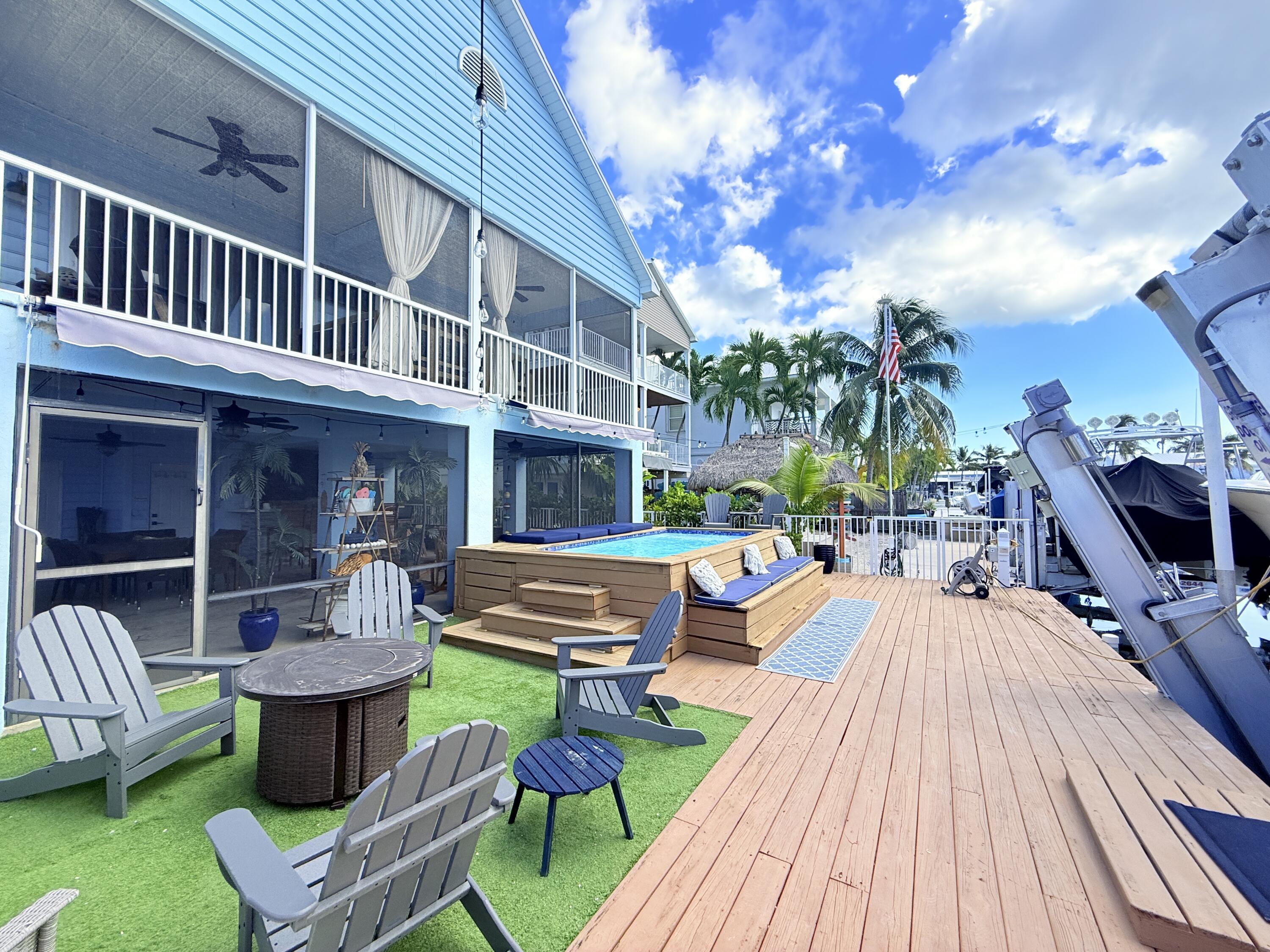 a view of a house with swimming pool and sitting area