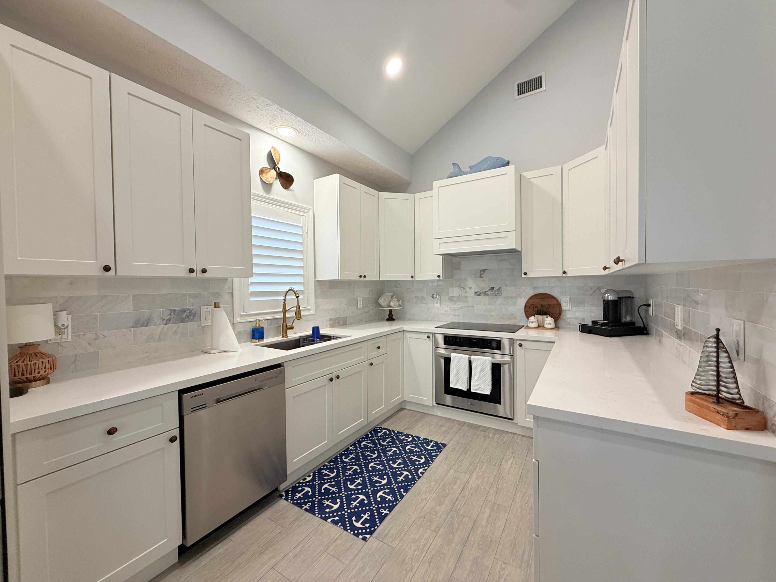 614 R Santa Anita Lane Key Largo, FL 33037 - Photo 11 of 64 a kitchen with granite countertop a sink stainless steel appliances and cabinets