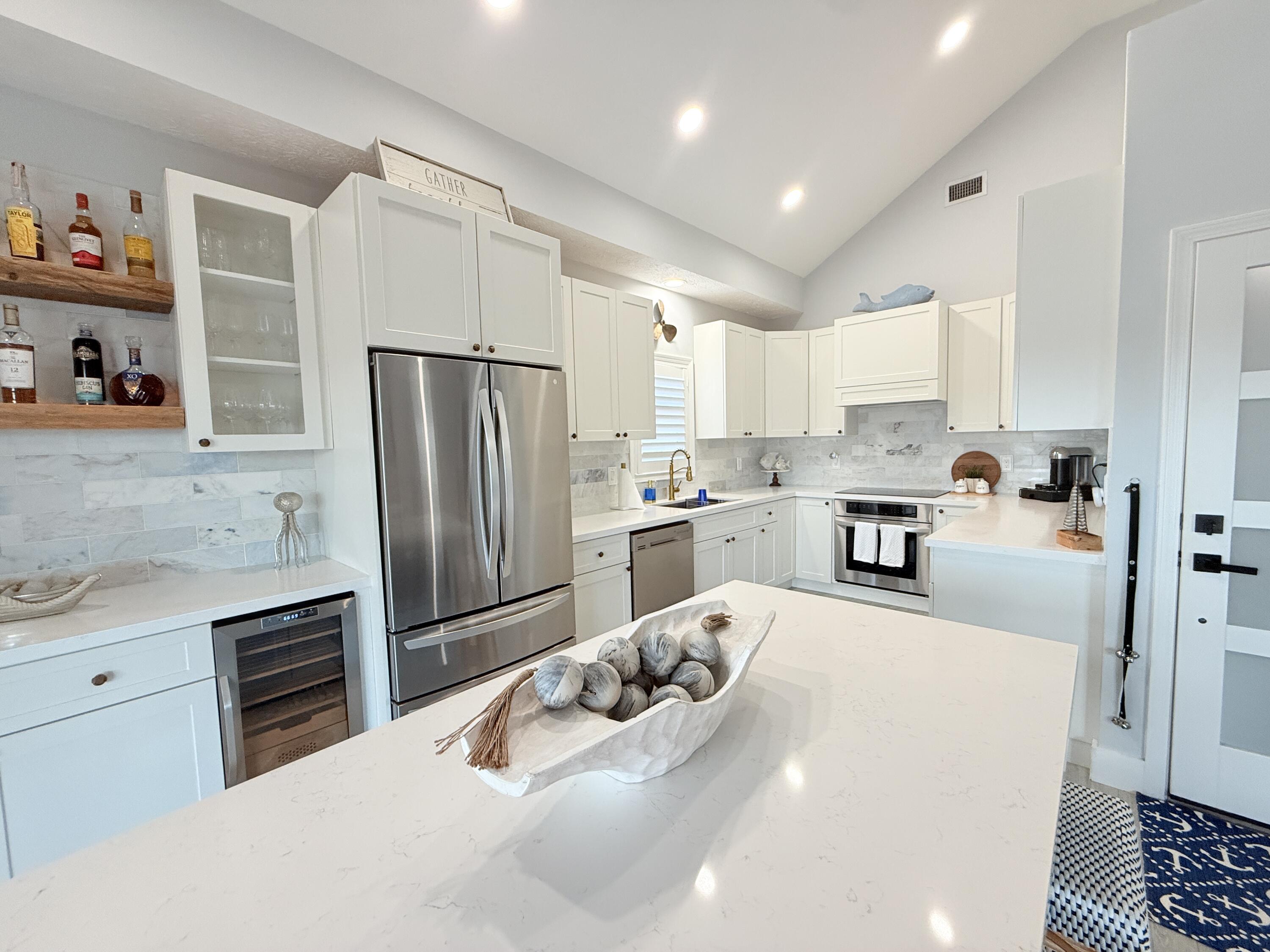 614 R Santa Anita Lane Key Largo, FL 33037 - Photo 12 of 64 a kitchen with a refrigerator a sink and cabinets
