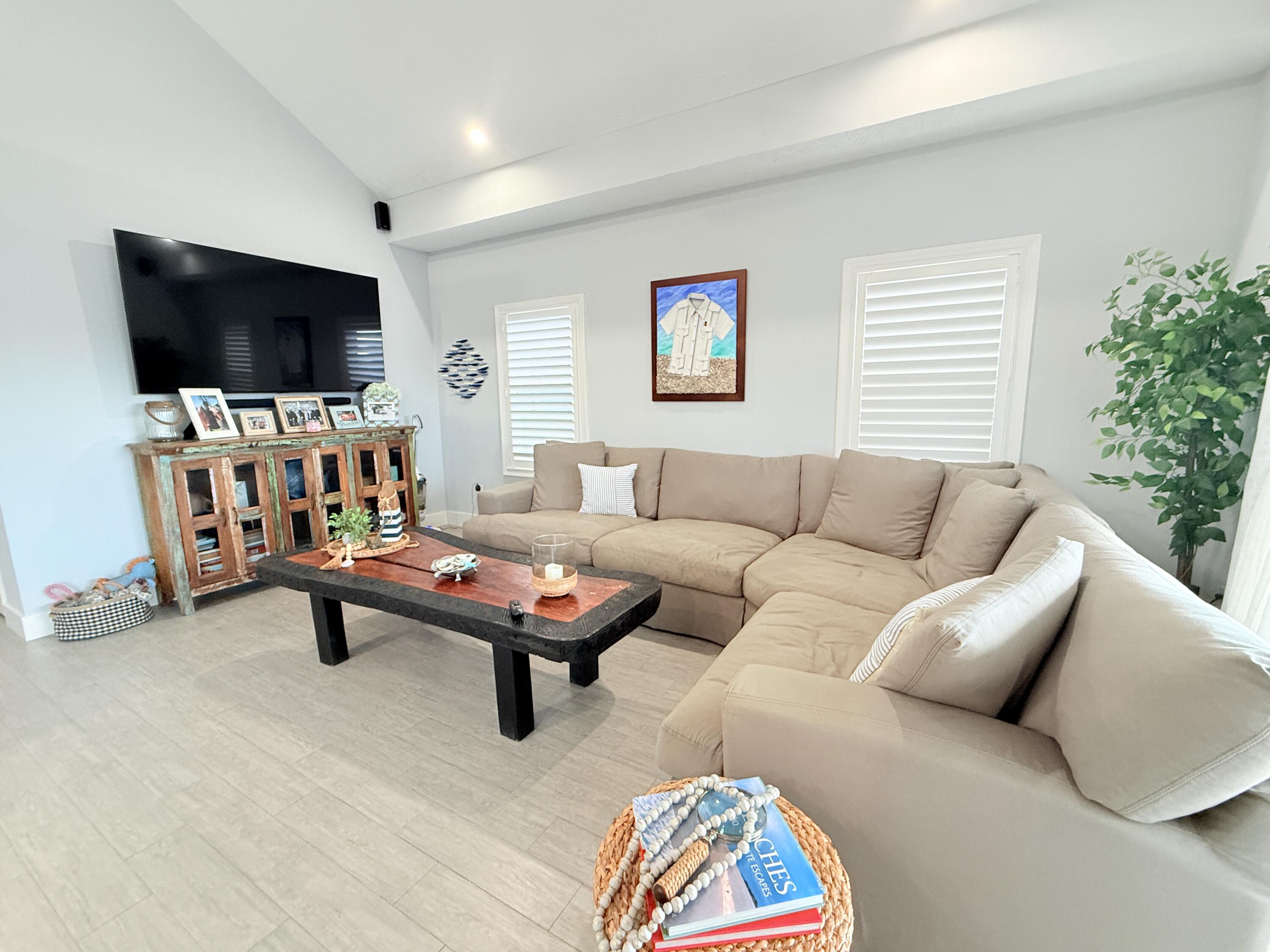 614 R Santa Anita Lane Key Largo, FL 33037 - Photo 19 of 64 a living room with furniture and a flat screen tv