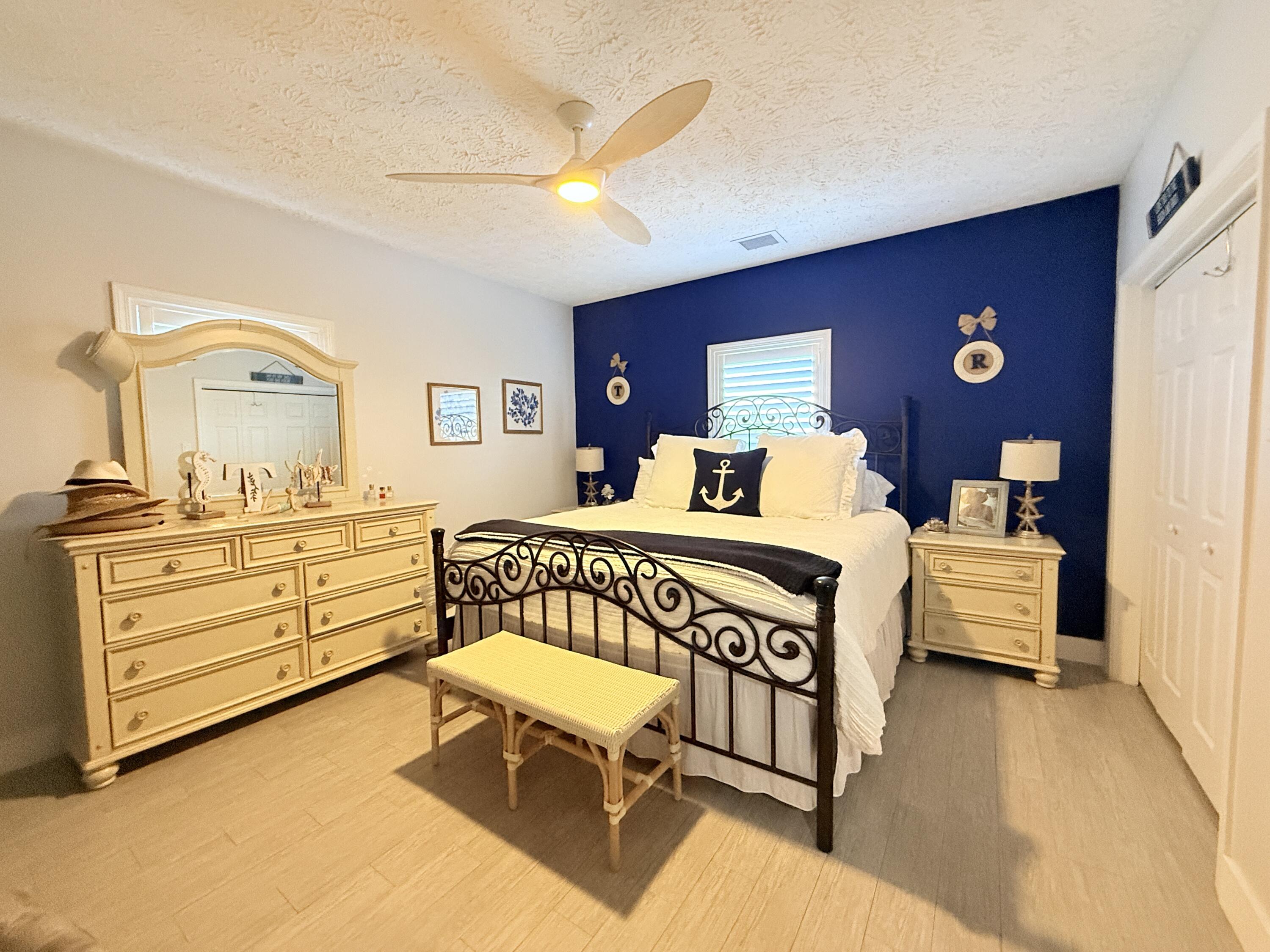 614 R Santa Anita Lane Key Largo, FL 33037 - Photo 23 of 64 a bedroom with a bed and wooden floor