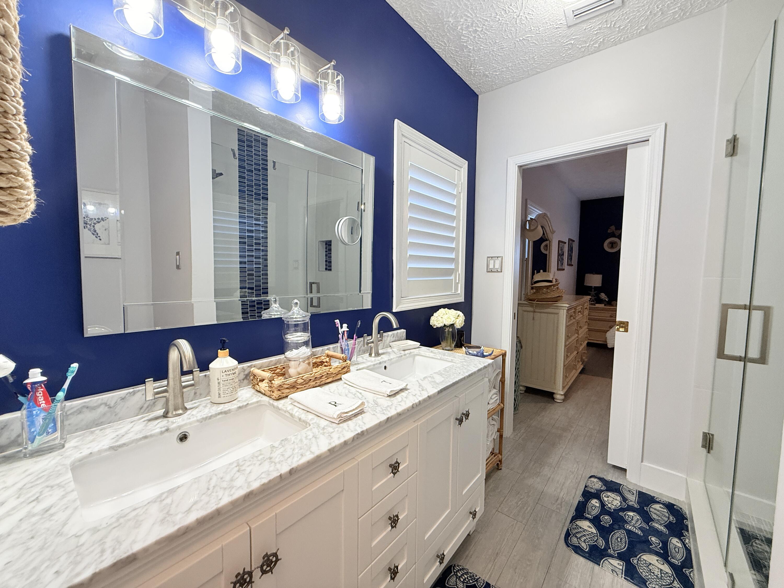 614 R Santa Anita Lane Key Largo, FL 33037 - Photo 26 of 64 a spacious bathroom with a double vanity sink a mirror and a shower