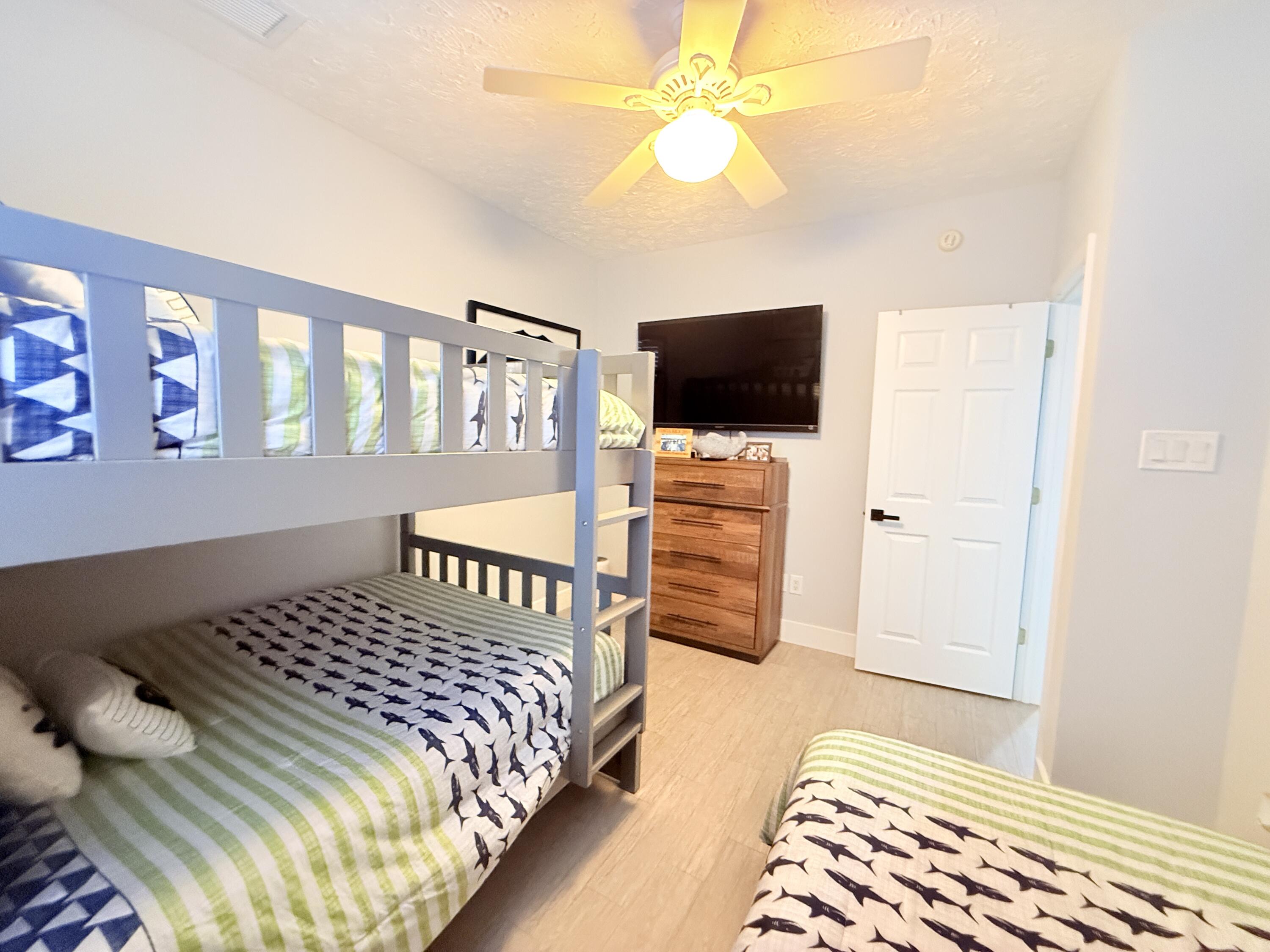 614 R Santa Anita Lane Key Largo, FL 33037 - Photo 31 of 64 a bedroom with a bed and flat screen tv