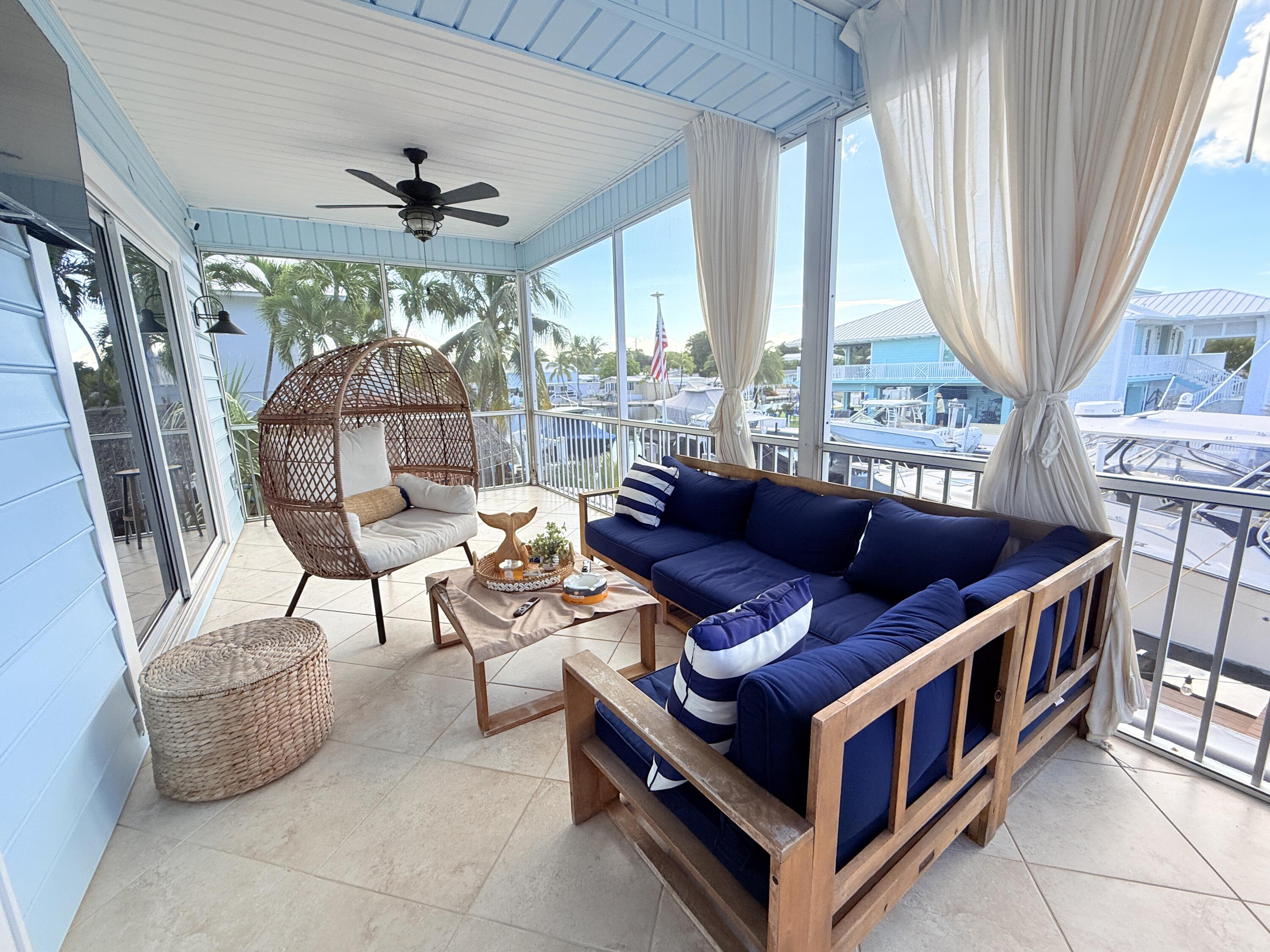 614 R Santa Anita Lane Key Largo, FL 33037 - Photo 35 of 64 a living room with furniture and a chandelier