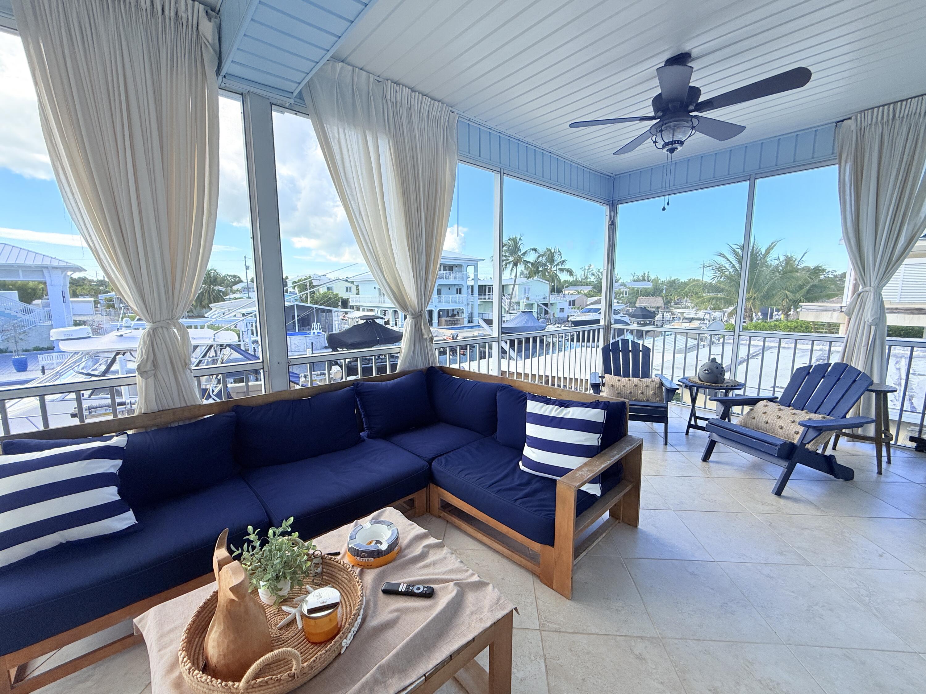 614 R Santa Anita Lane Key Largo, FL 33037 - Photo 37 of 64 a living room with furniture and a large window
