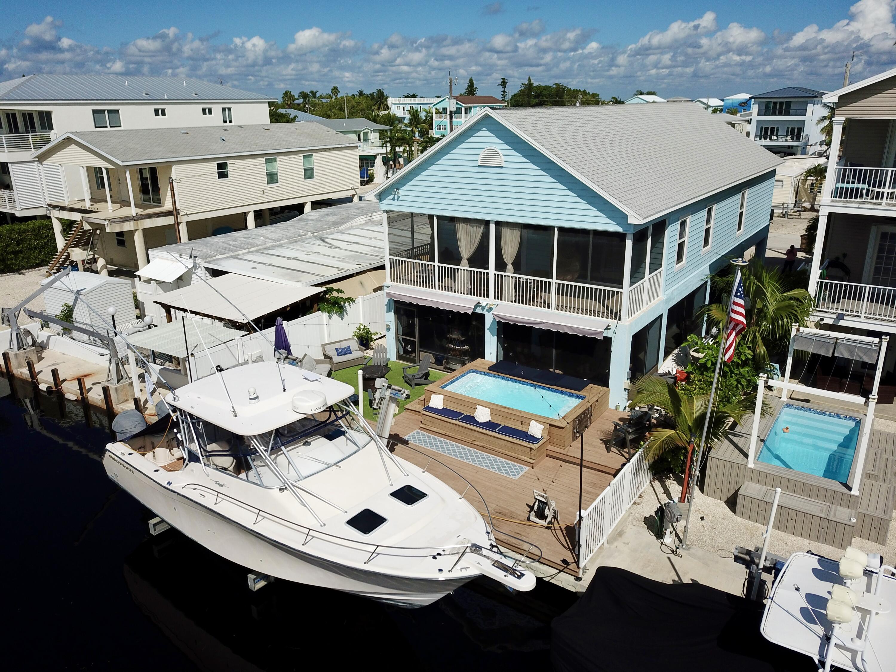 614 R Santa Anita Lane Key Largo, FL 33037 - Photo 4 of 64 an aerial view of a house with garden