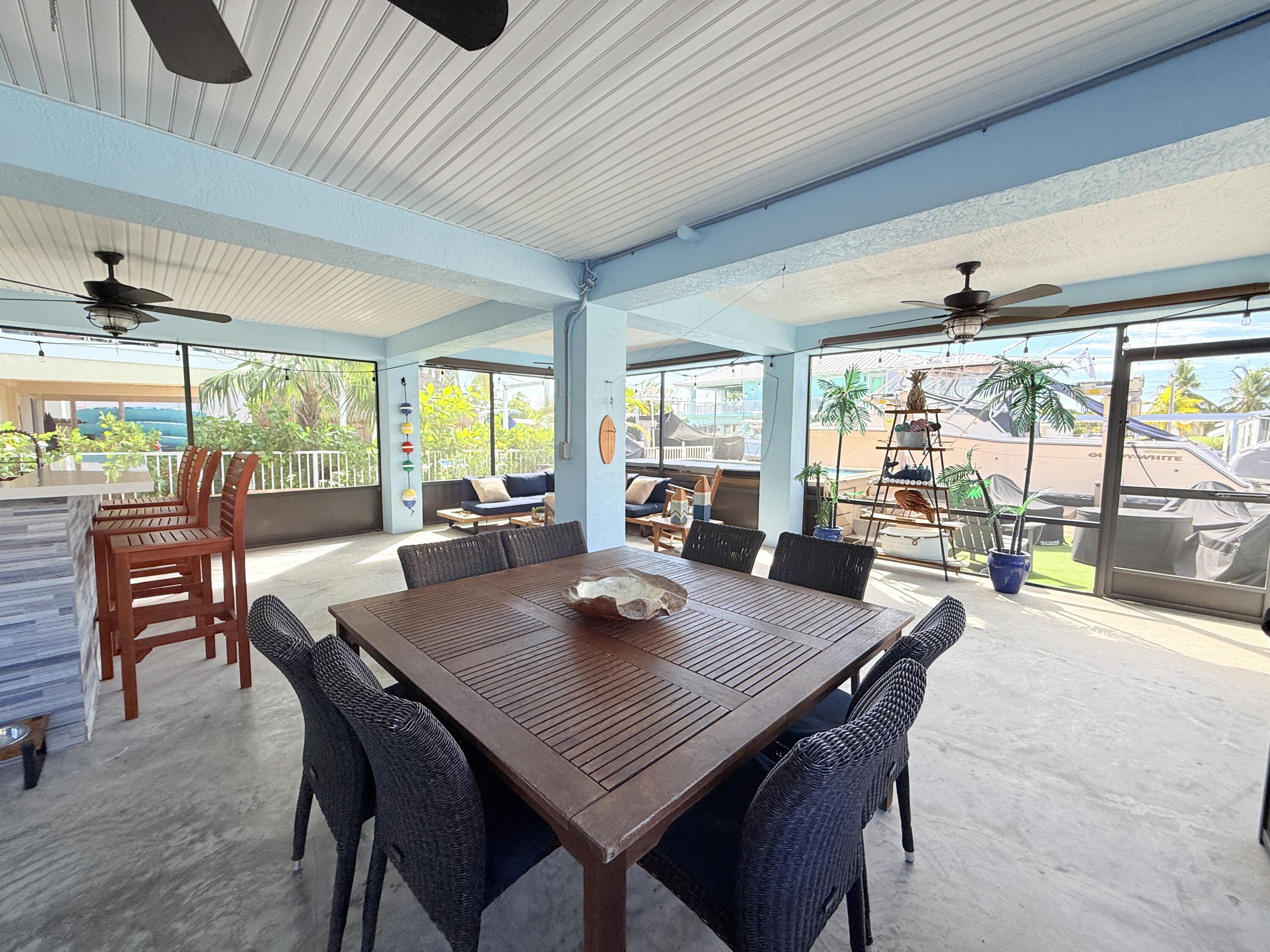 614 R Santa Anita Lane Key Largo, FL 33037 - Photo 42 of 64 a view of a dining room with furniture window and outside view