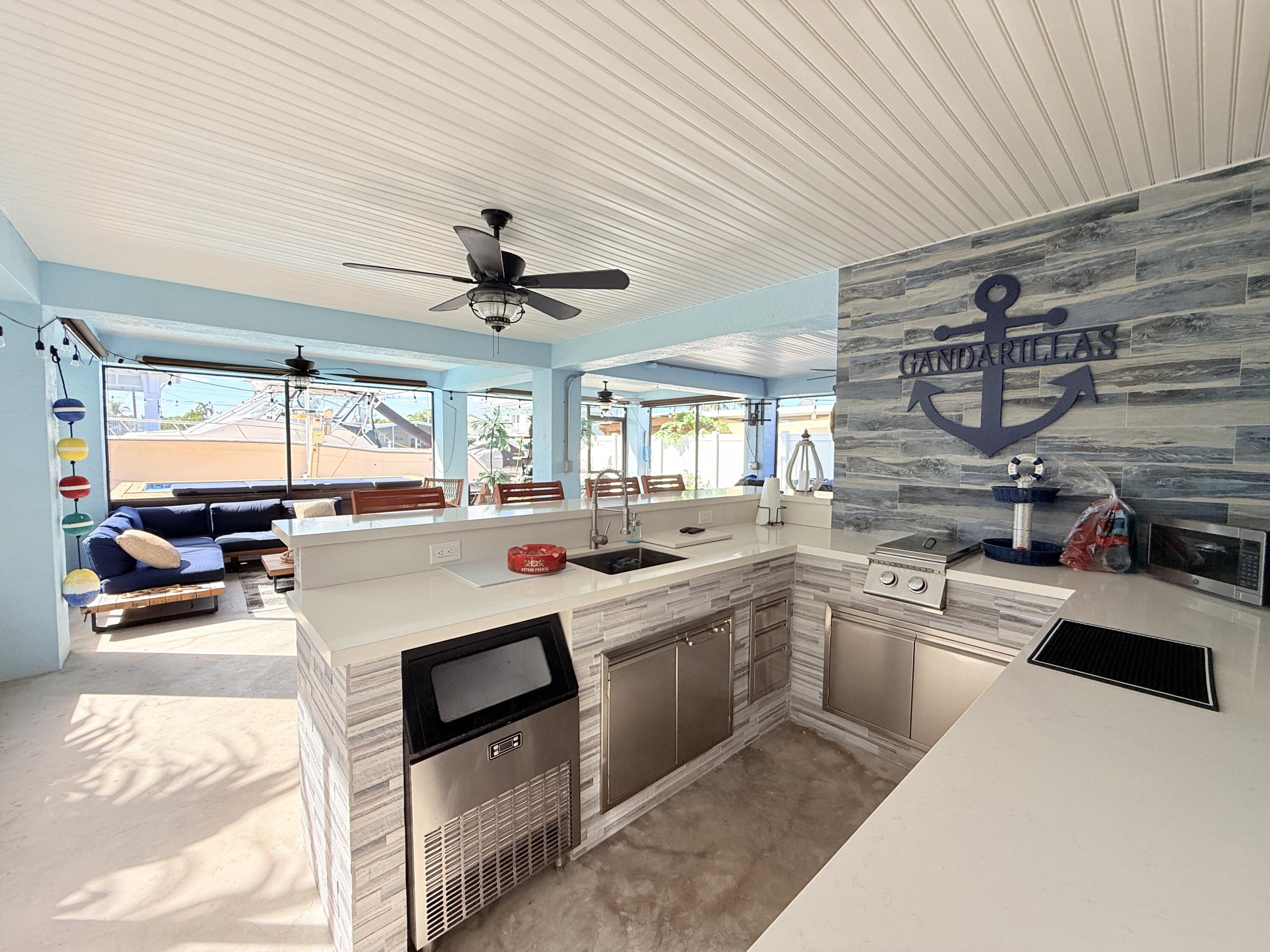 614 R Santa Anita Lane Key Largo, FL 33037 - Photo 48 of 64 a kitchen with stainless steel appliances a stove a sink and a refrigerator