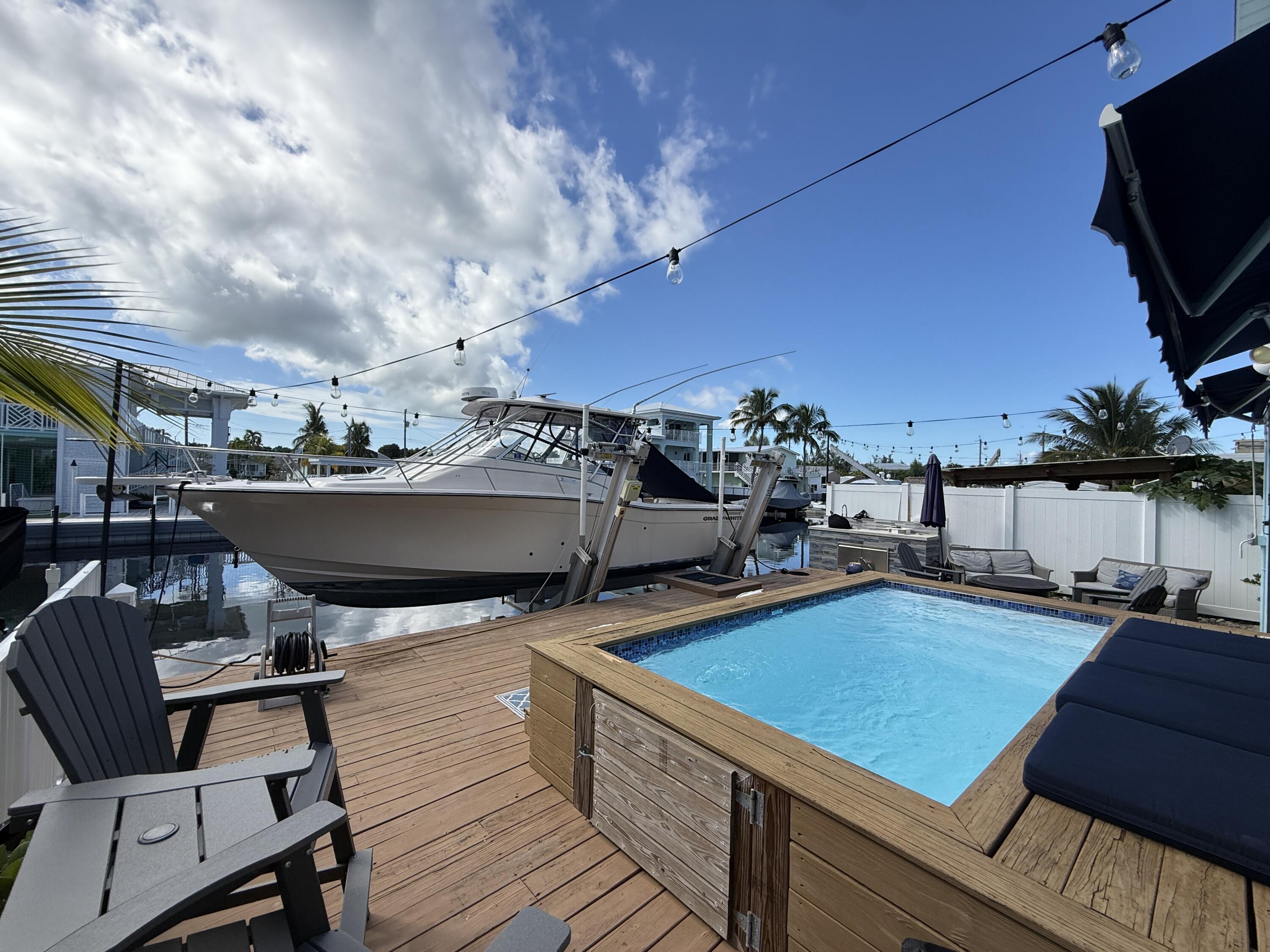 614 R Santa Anita Lane Key Largo, FL 33037 - Photo 5 of 64 a view of a chairs and table on the terrace