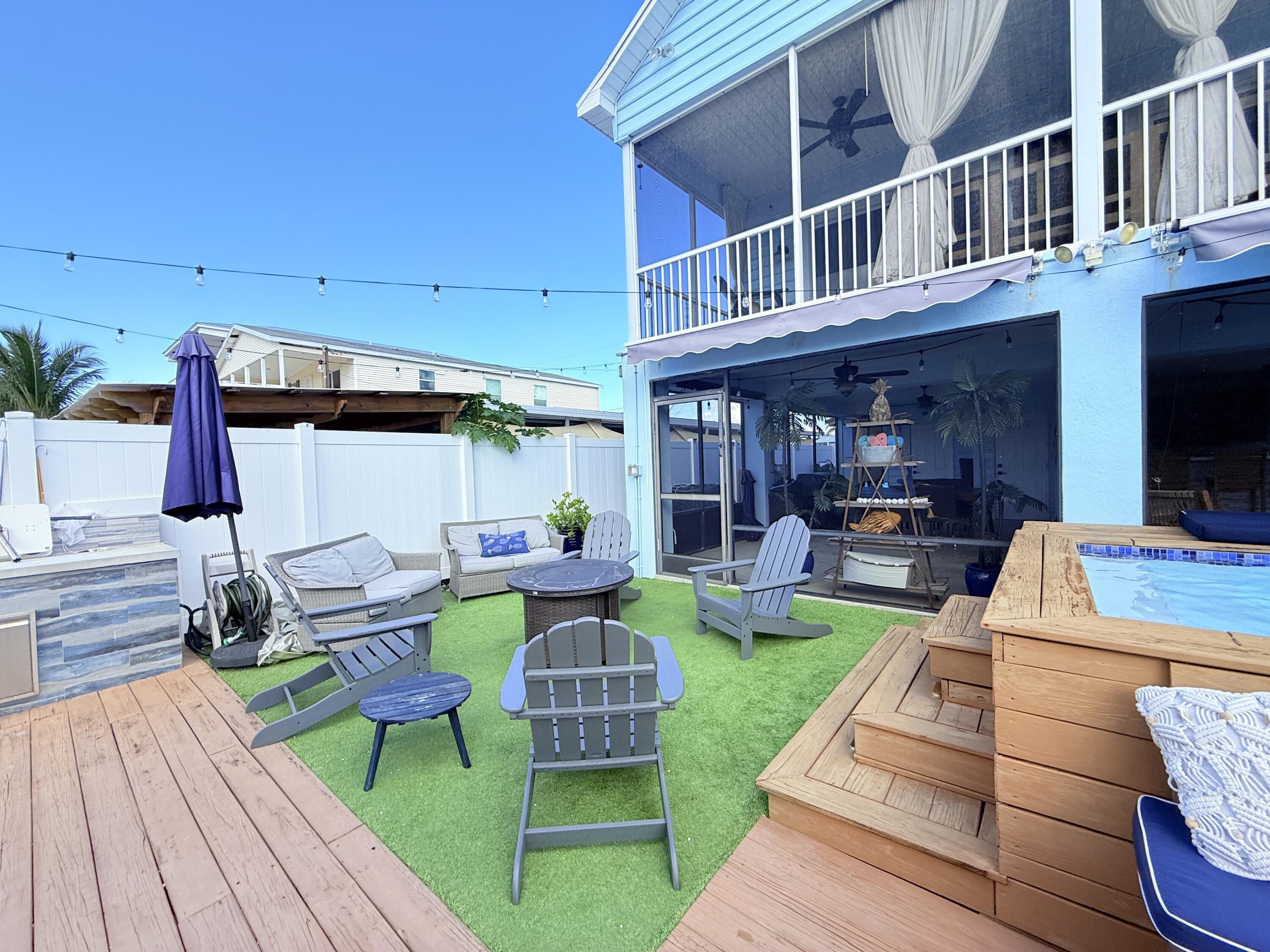 614 R Santa Anita Lane Key Largo, FL 33037 - Photo 55 of 64 a view of a house with backyard sitting area and furniture