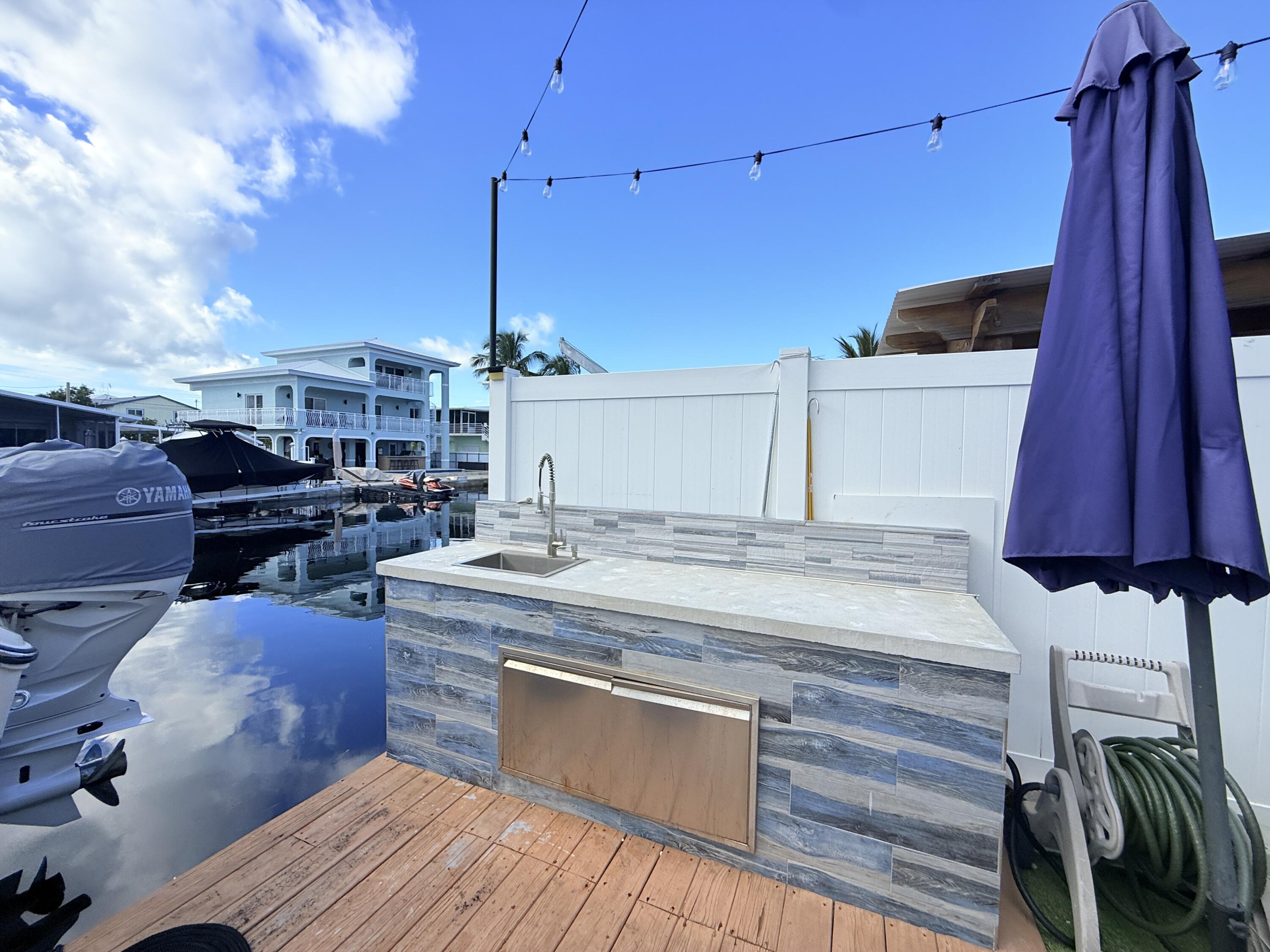 614 R Santa Anita Lane Key Largo, FL 33037 - Photo 56 of 64 a kitchen with a sink and cabinets