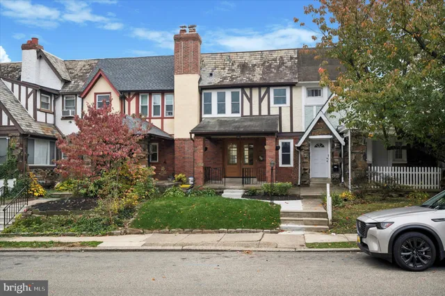 a car parked in front of a brick house