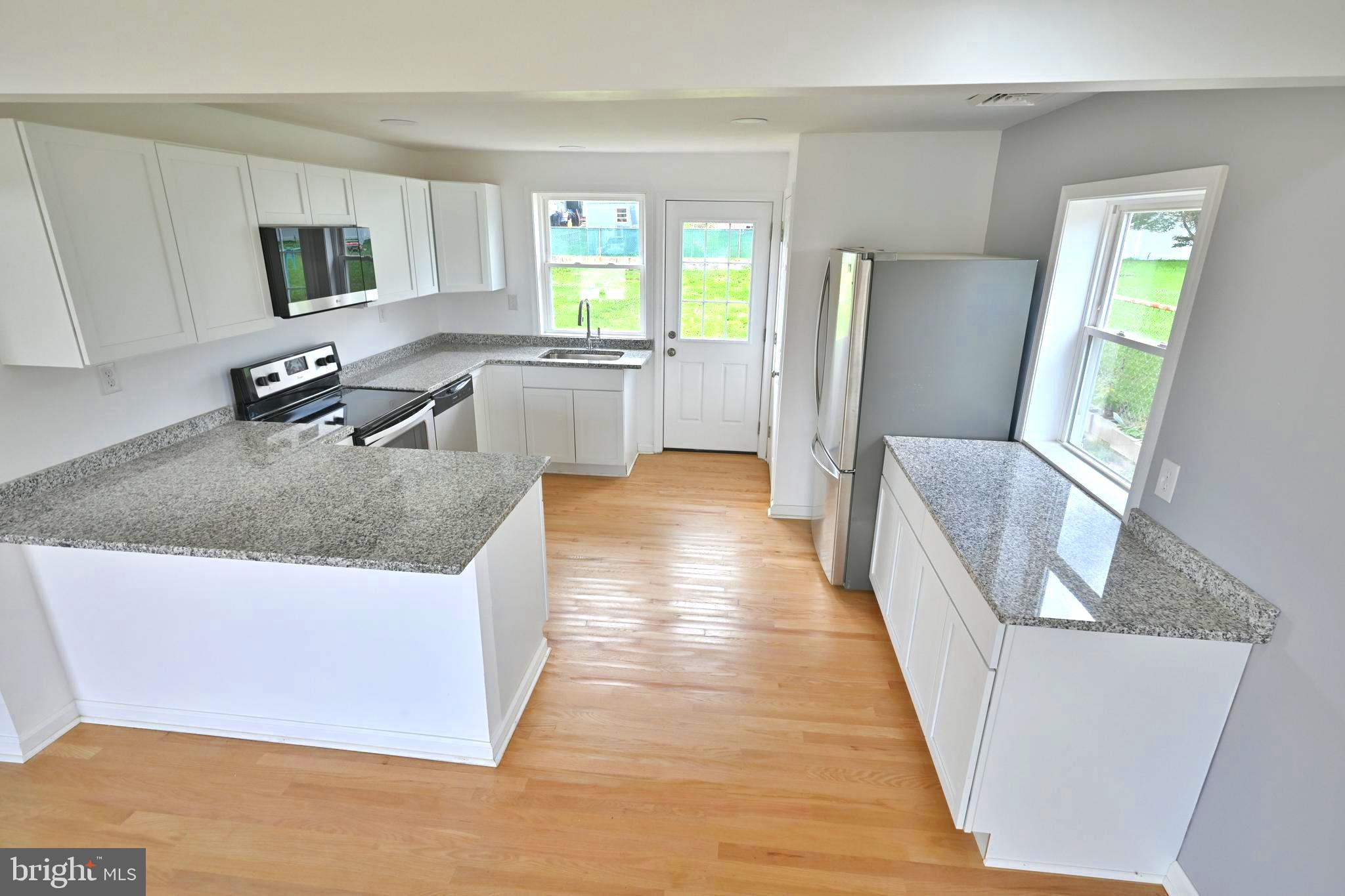 34 Compass Road East Middle River, MD 21220 - Photo 9 of 25 a kitchen with sink refrigerator and window