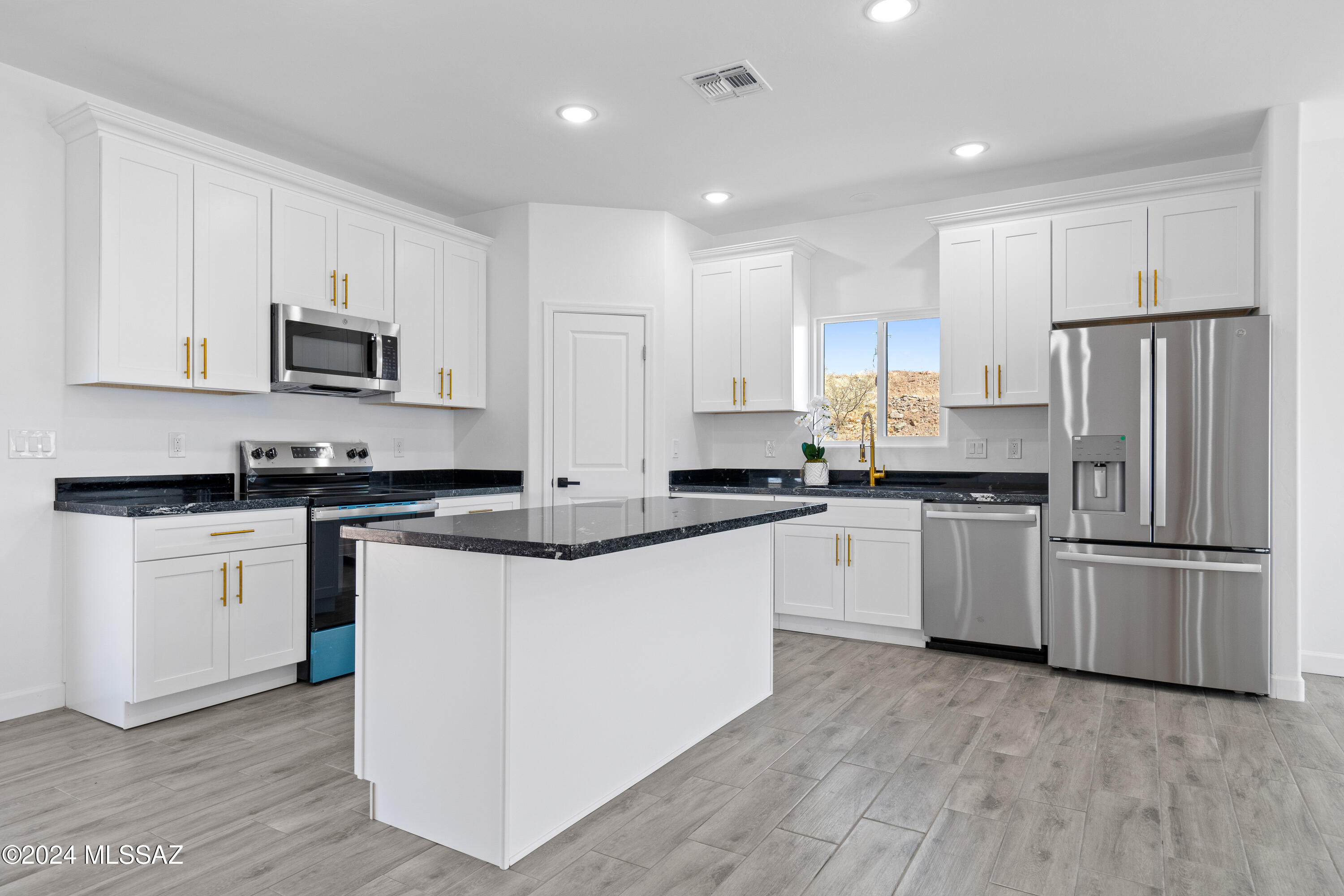 1874 Circulo Colombia Rio Rico, AZ 85648 - Photo 12 of 31 a kitchen with granite countertop white cabinets and stainless steel appliances
