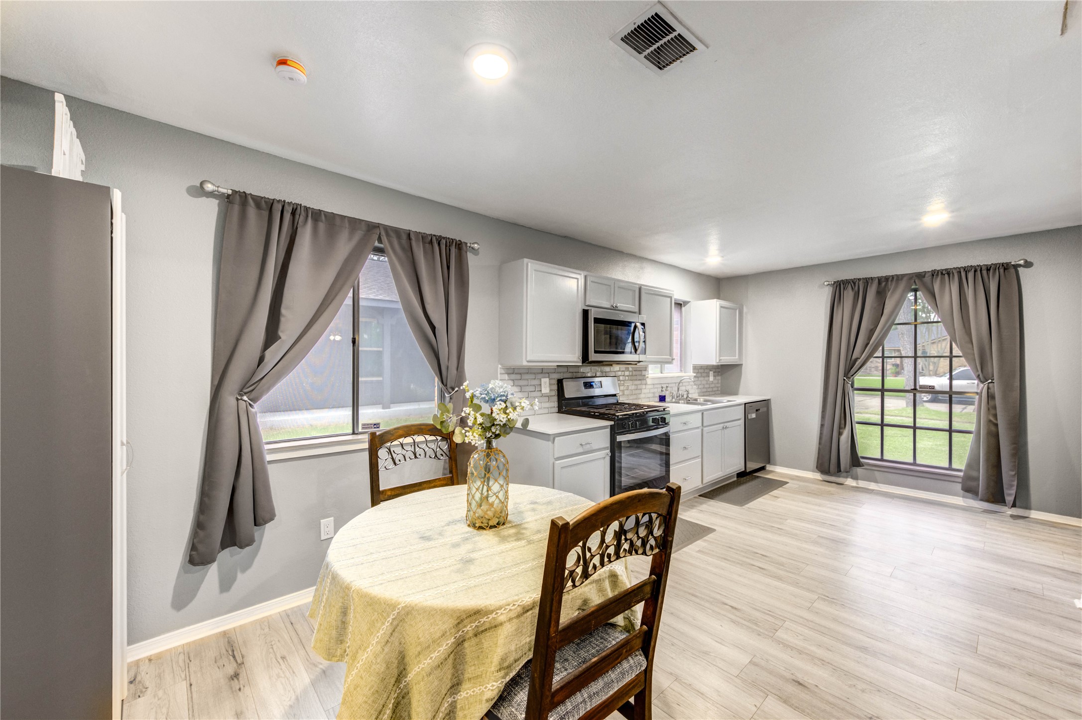 8510 Collingdale Road La Porte, TX 77571 - Photo 8 of 20 a kitchen with sink refrigerator dining table and chairs