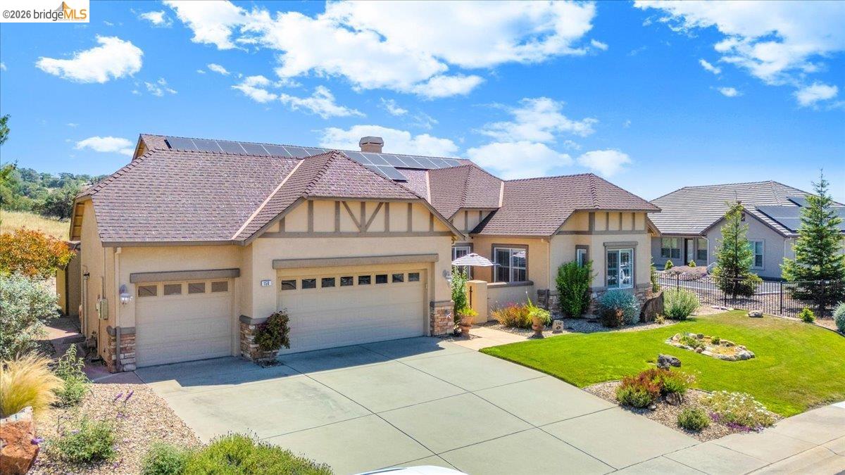 158 Rock Ridge Lane Copperopolis, CA 95228 - Photo 3 of 72 Tudor-style exterior with a stucco finish, stone accents, and 28 solar panels