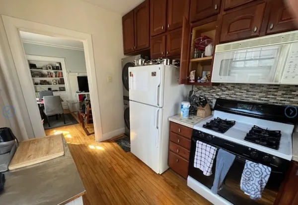 a kitchen with stainless steel appliances granite countertop a stove refrigerator and a sink