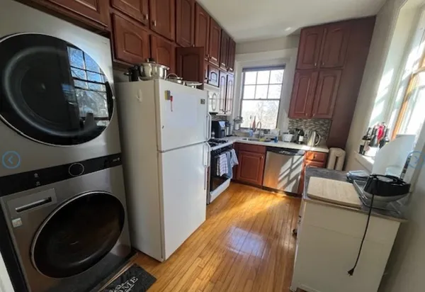 a kitchen with a sink a refrigerator and washer