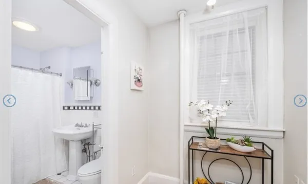 a bathroom with a sink a toilet and a mirror